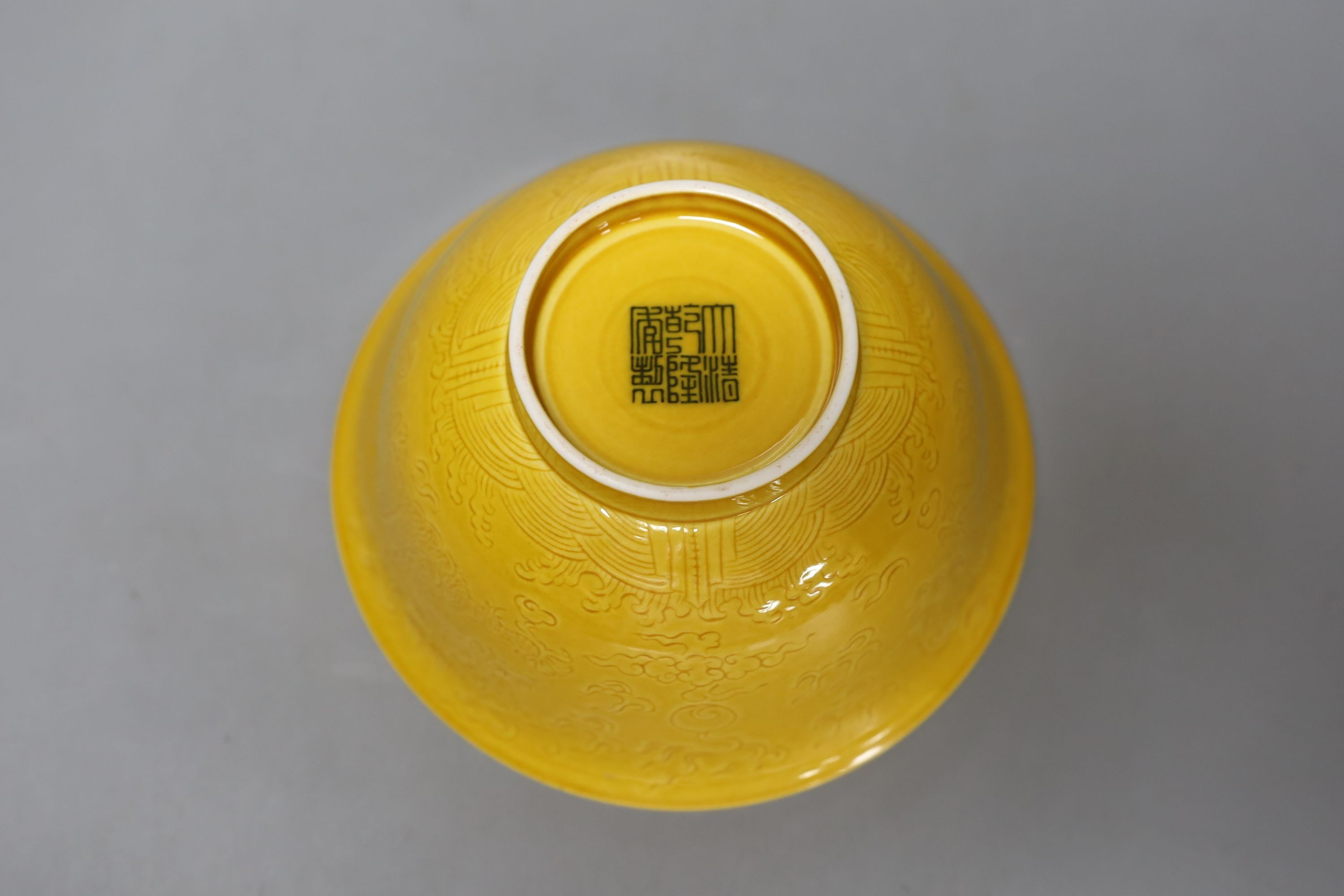 Three Chinese ceramics, including a yellow bowl with inscription to base, 7cm tall, blue and white dragon pattern candlestick mount and export dish